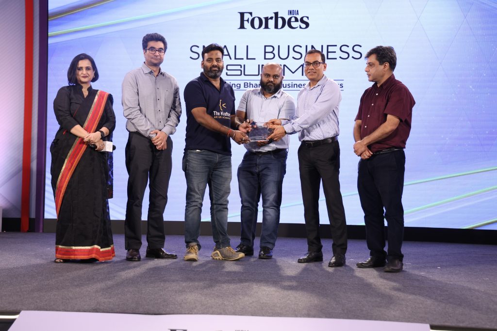 Kraftors Web Solutions owner receiving an appreciation  on stage for excellence in web development and innovation."